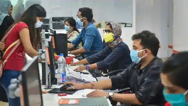 Bank employees wear masks as a precautionary measure following the coronavirus pandemic. (PTI)